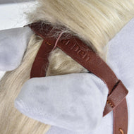 Nahaufnahme eines Plüschpferdekopfs mit hellgrauen Ohren, cremefarbener Mähne und brauner Komplette Westerntrense Einohr aus Leder von Hobby Horse LarDen mit Nähten, geprägtem Logo und Split Reins.