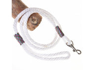 The Hobby Horse LarDen Hobby Horse - Leash White is a quality white braided rope leash with colorful thread accents, featuring a metal clip and hand loop, shown looped around a wooden branch.