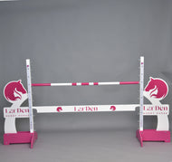 LarDen jump 110 cm / 43 inch de Hobby Horse LarDen, avec des barres roses et blanches, des silhouettes de tête de cheval et une hauteur réglable, idéal pour monter à Hobby Horse. Marque : Hobby Horse LarDen. Présenté sur fond gris uni.