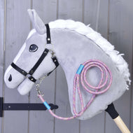 The Hobby Horse LarDen Hobby Horse - Lead rope Bubble features a grey horse with white mane, black bridle, and a pink-and-purple lead rope, mounted on a wooden stick against a grey wooden background.