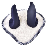 A close-up of the Hobby Horse LarDen Ear Bonnet Cube Blue, featuring soft navy ear-like protrusions on a white fuzzy base with black and white checkered trim for stylish horse insect protection.