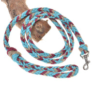 The Hobby Horse LarDen braided lead rope in turquoise is coiled on a tree branch with a metal clasp—ideal for use as a hobby horse lead or sturdy lunging rope.
