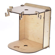 The Hobby Horse LarDen Small Hobby Horse Stable features a minimalist design with a flat base, vertical back panel, top shelf with cut-out hooks, laser-engraved logo on the base, and a central hole for cable management.