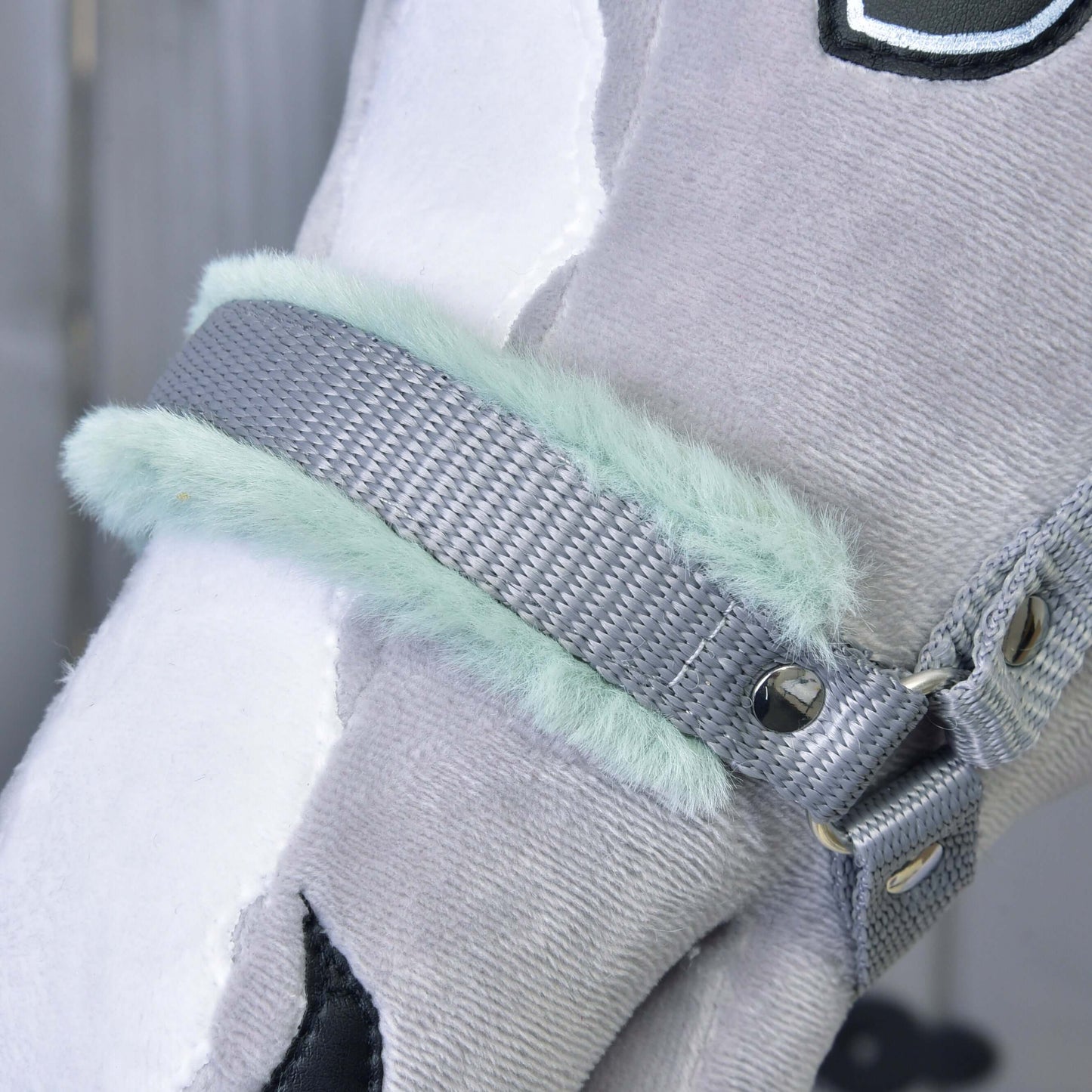 Close-up of a plush gray and white toy horse head with the "Hobby Horse LarDen" Halter grey with mint fur, featuring soft mint faux fur lining, metal rivets, and detailed stitching—a charming hobby horse accessory.