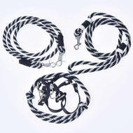 The Set Start Black by Hobby Horse LarDen includes a halter, cordeo, lead rope, and reins—each black with white stripes and silver clips—displayed on a white background with one coiled and the others loosely looped.