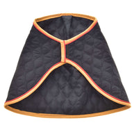 The Blanket Flag by Hobby Horse LarDen is a black quilted cape with tan and red trim, inspired by a warm horse blanket, featuring an open front and diamond stitching.