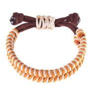 The Bracelet Orange by Hobby Horse LarDen features intertwined orange and white cords inspired by a rope set, a brown adjustable band, and decorative knots for added style.