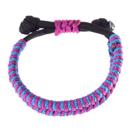 The Bracelet Princess by Hobby Horse LarDen features a black cord with alternating pink and blue woven threads, knotted ends, and a central pink decorative knot—ideal for accessorizing your Hobby Horse or as a chic rope set piece.