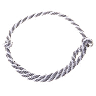 The Cordeo silver stripe by Hobby Horse LarDen features a handmade twisted black and white design, arranged in a circular shape with a simple knot on the right, displayed against a white background.