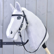 A gray plush hobby horse with a white blaze, wearing the Hobby Horse LarDen Complete bridle without noseband Pure Black, is mounted on a wooden stick and set against a light gray wooden background.