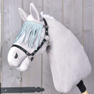 A Hobby Horse LarDen model in light grey features a soft, plush face, white mane, and is fitted with the "Halter black with fringes turquoise light," including a stylish black bridle and turquoise fringe browband against a wooden background.