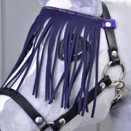 A close-up of a gray hobby horse head wearing the Hobby Horse LarDen Halter black with lila fringes, featuring black leather reins and decorative purple fringe covering its eyes.